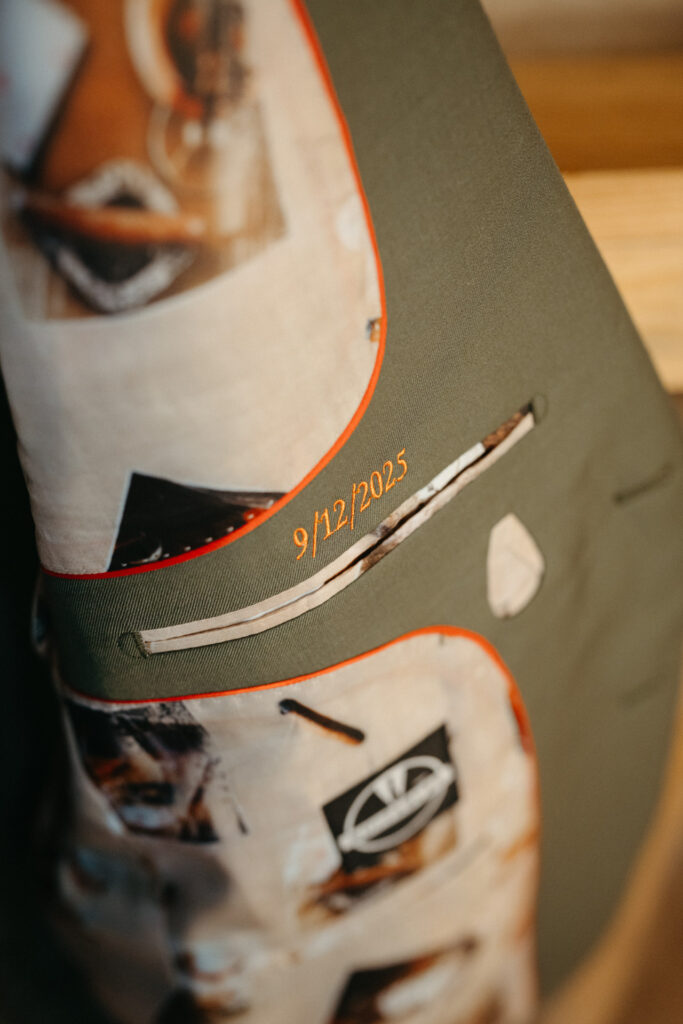Close-up of a suit jacket lining printed with photos and an embroidered date