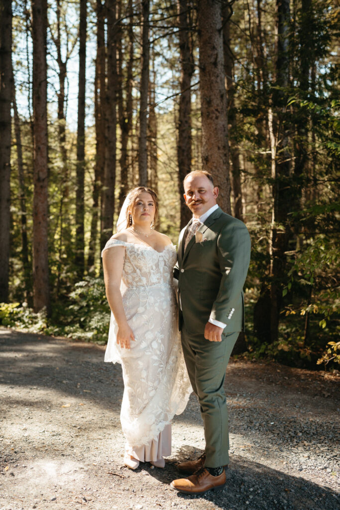 Couple standing side by side on a forest path