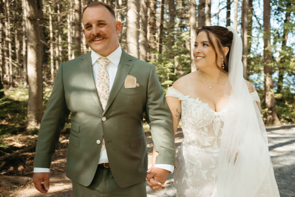 Couple walking hand in hand and smiling at each other