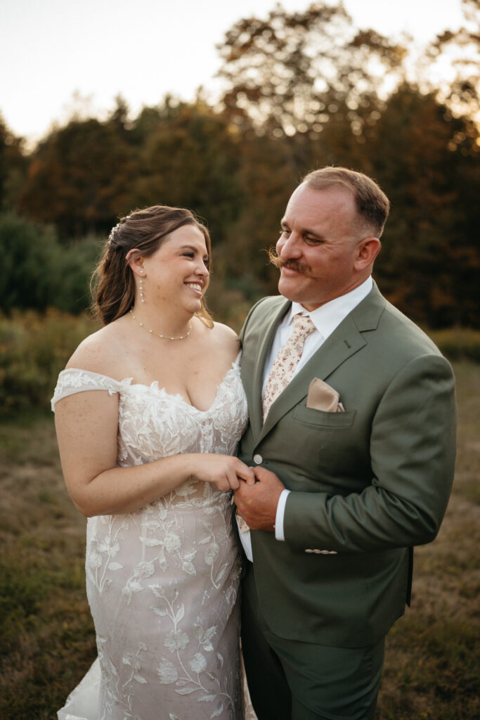 Couple laughing and holding hands in golden light