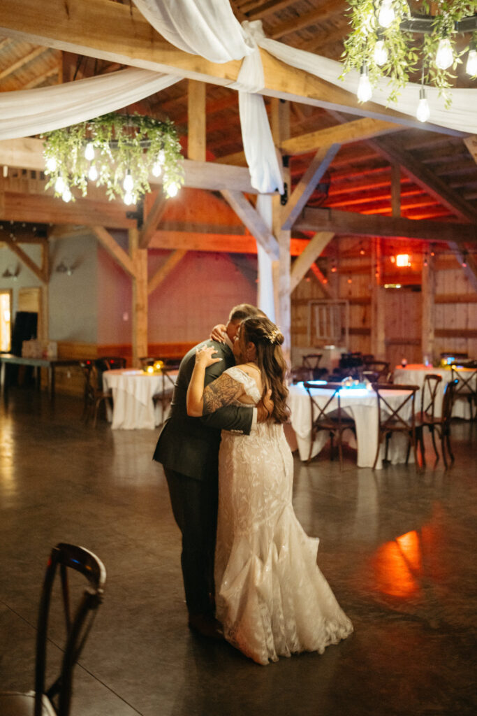 Couple slow dancing in the empty barn
