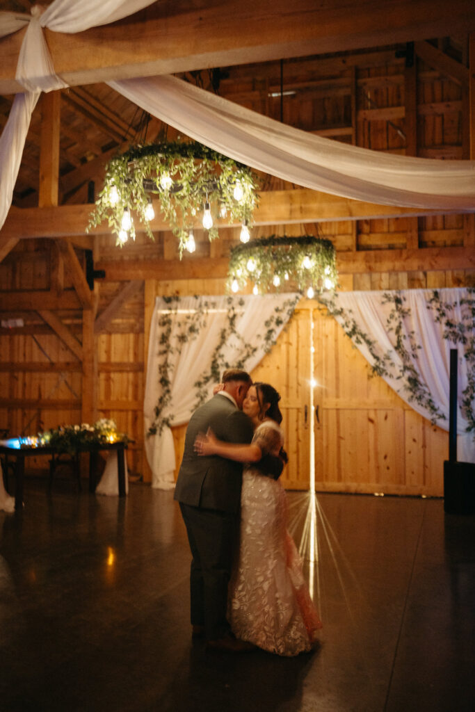 Couple embracing on the dance floor under a chandelier