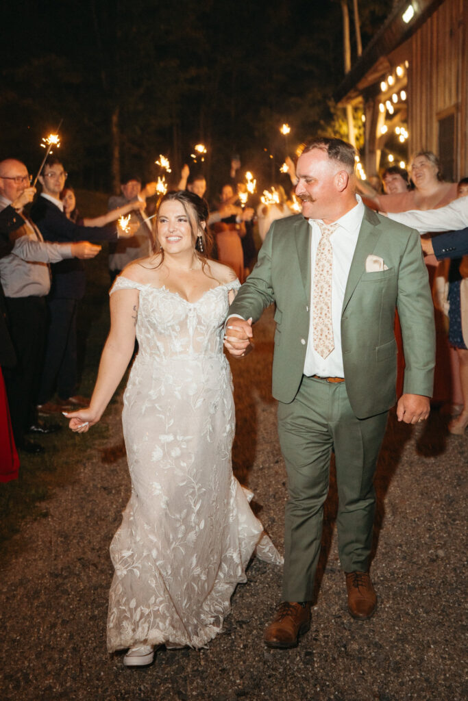 Couple walking through a sparkler send-off
