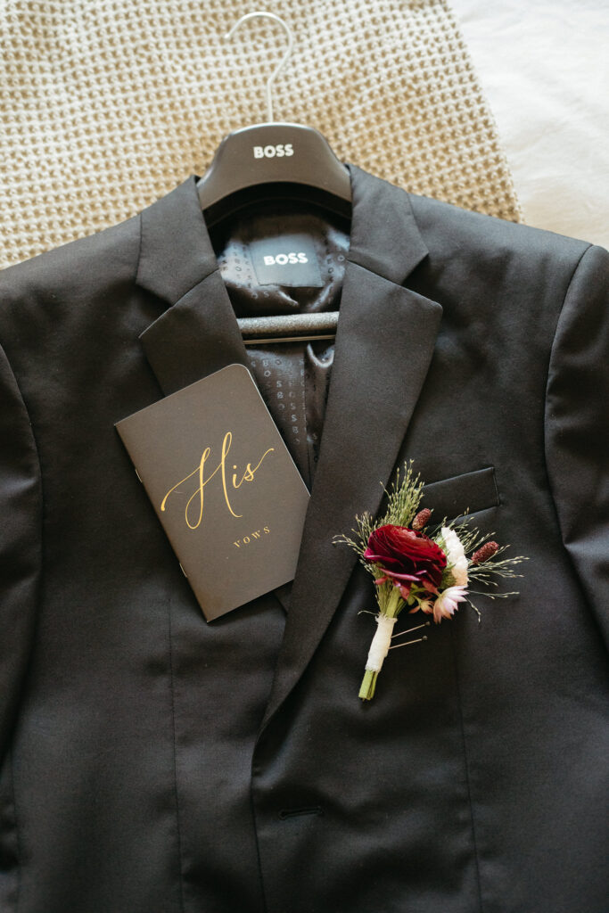 Suit jacket on a hanger with a program card and boutonniere