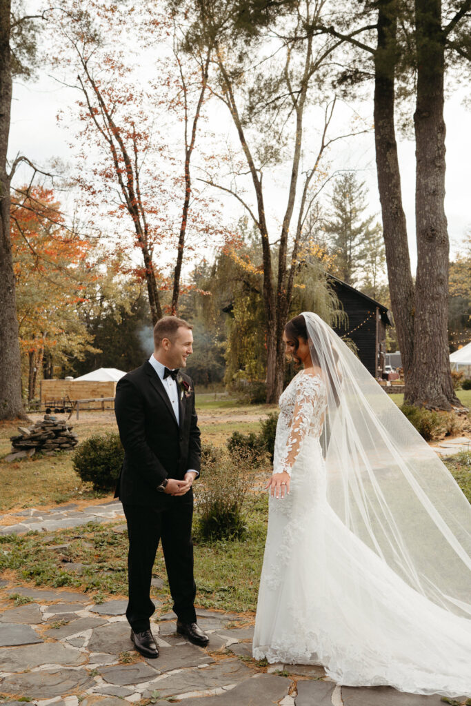Couple standing apart on a stone path in autumn woods