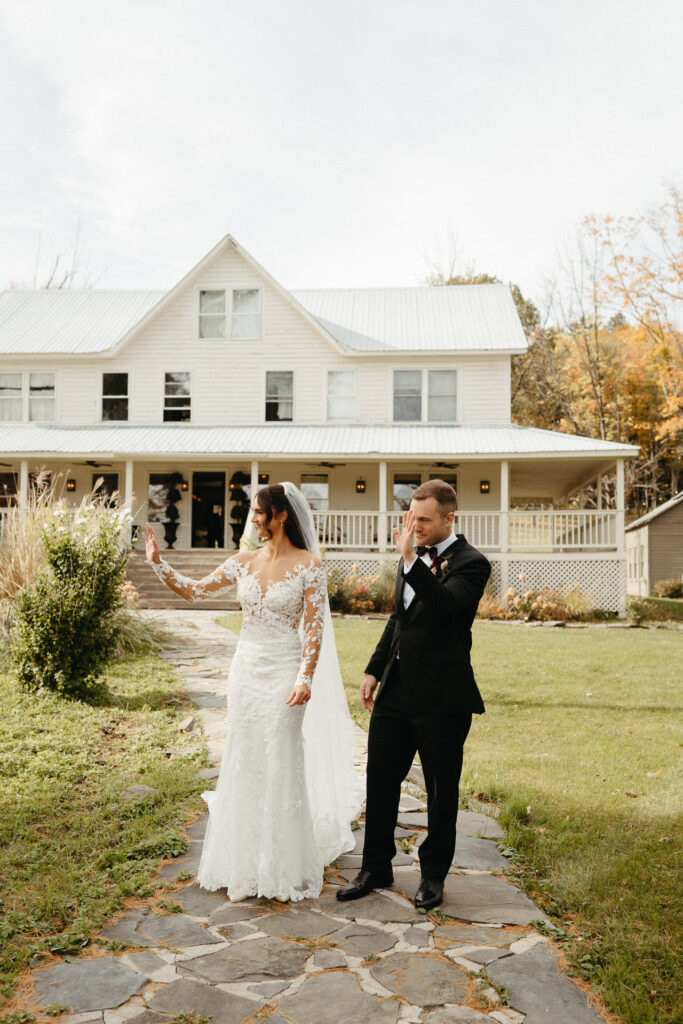 Couple at their first look in front of the farmhouse