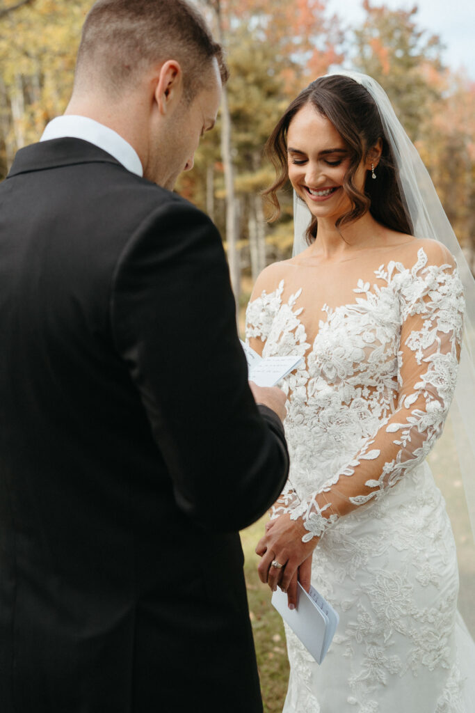 Close-up of a person reading a note while their partner smiles