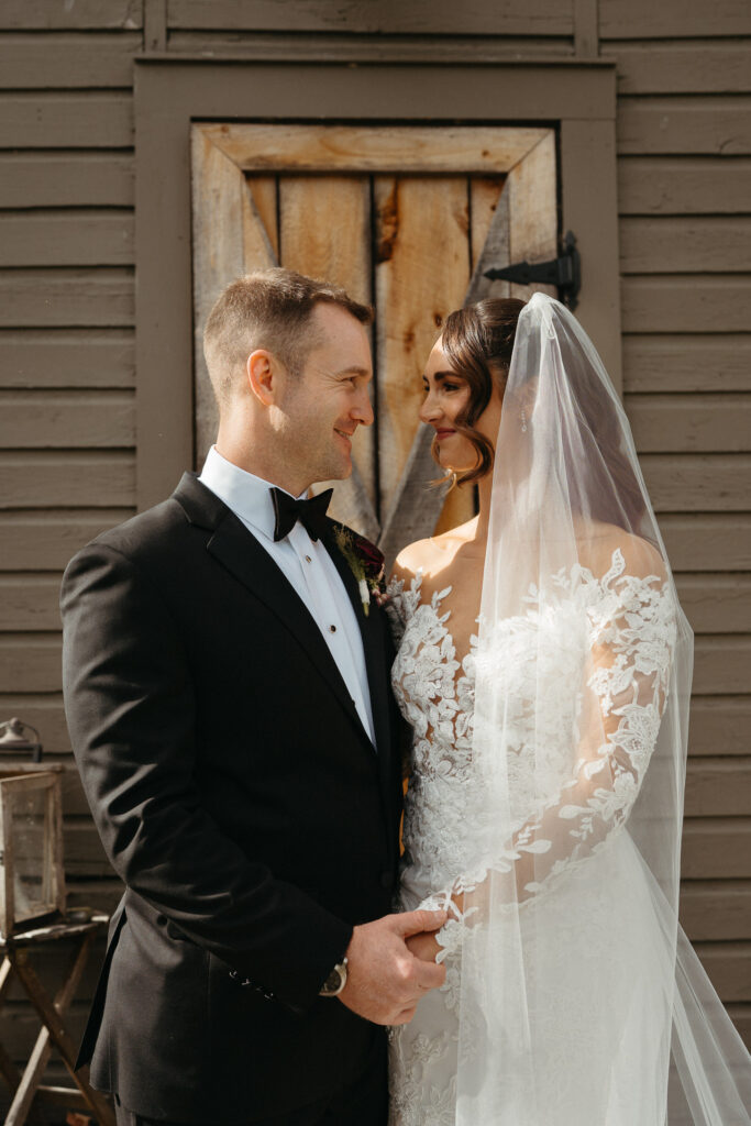 Couple smiling at each other in front of the cabin door