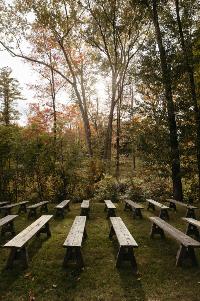 Wooden benches facing a woodland ceremony space