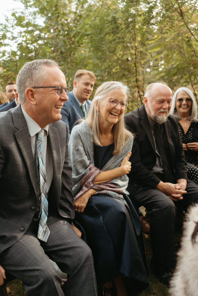 Guests laughing and smiling during the ceremony