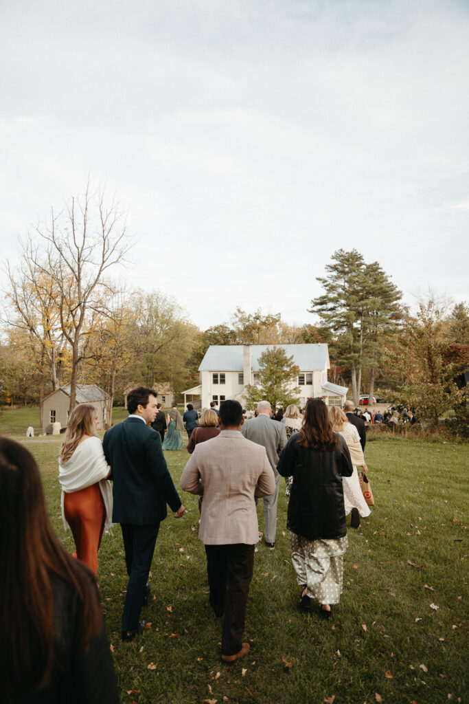 Guests walking across the lawn toward cocktail hour