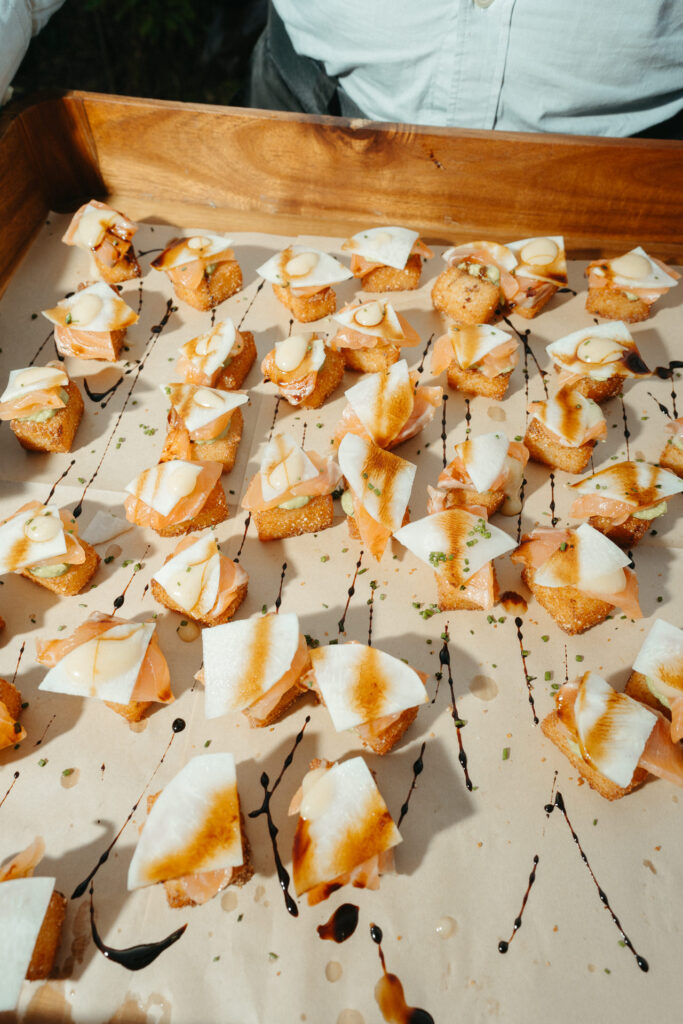 Tray of fried bites drizzled with sauce