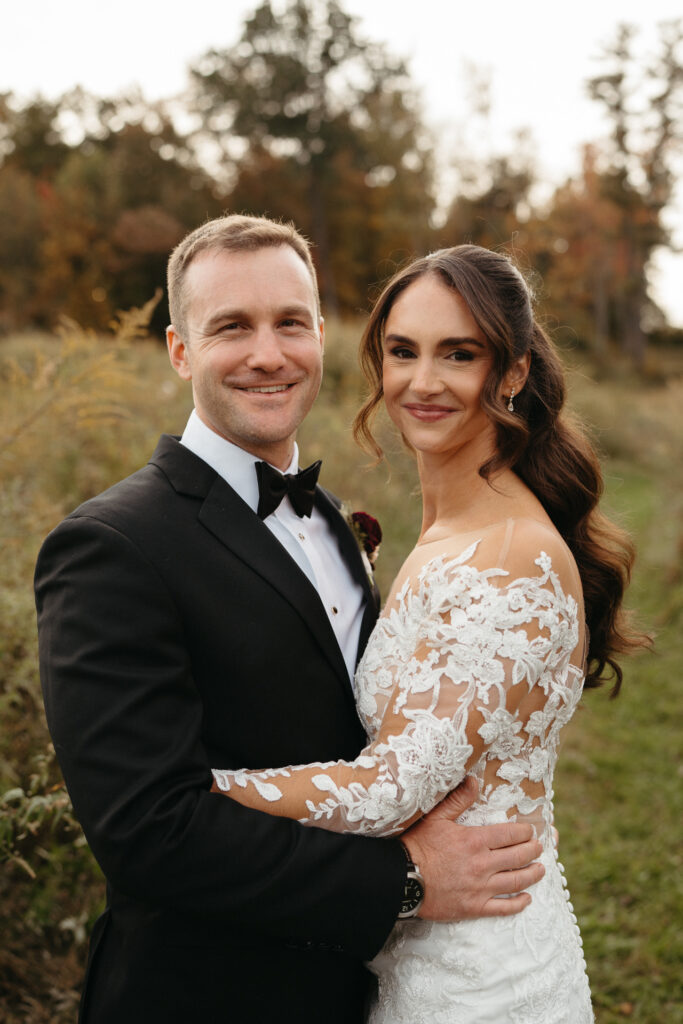 Couple smiling and embracing in a golden field