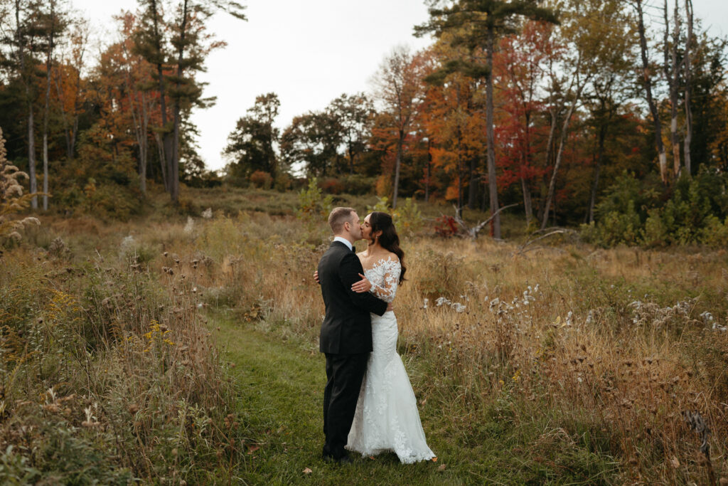 Couple embracing in a distant meadow among autumn trees