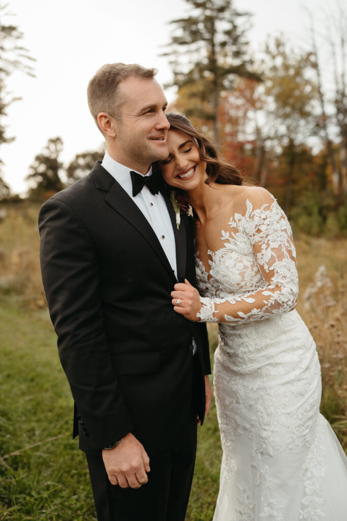 Couple laughing and embracing in a field