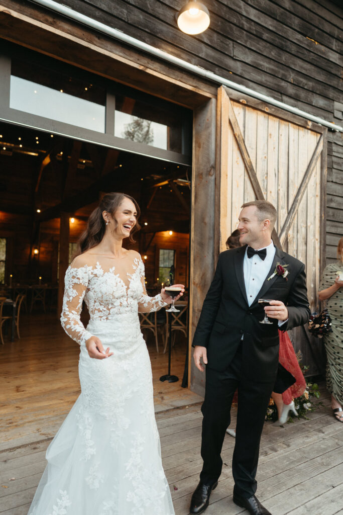 Couple laughing together at the barn doorway