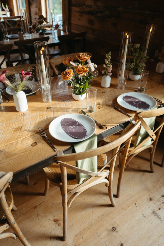 Barn dining table set with flowers and plum place cards