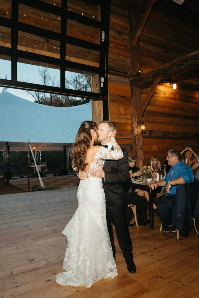 Couple beginning their first dance in the barn