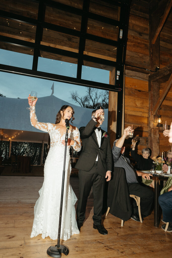 Couple raising a glass at the microphone