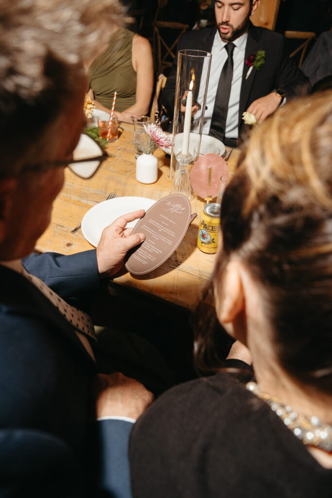 Close-up of guests passing a dish at a table