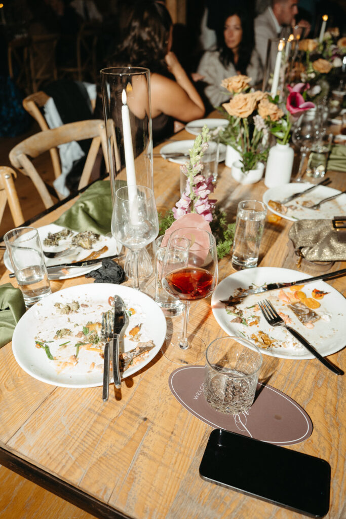 Table with empty plates and a phone after dinner