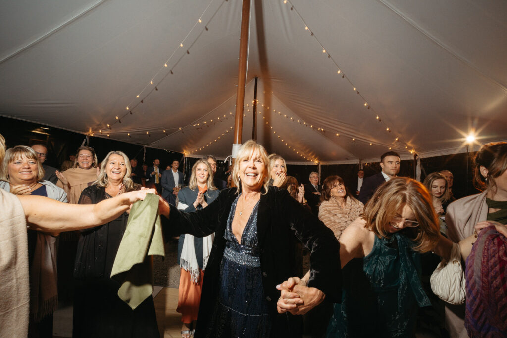 Guests dancing in the tent with napkins overhead