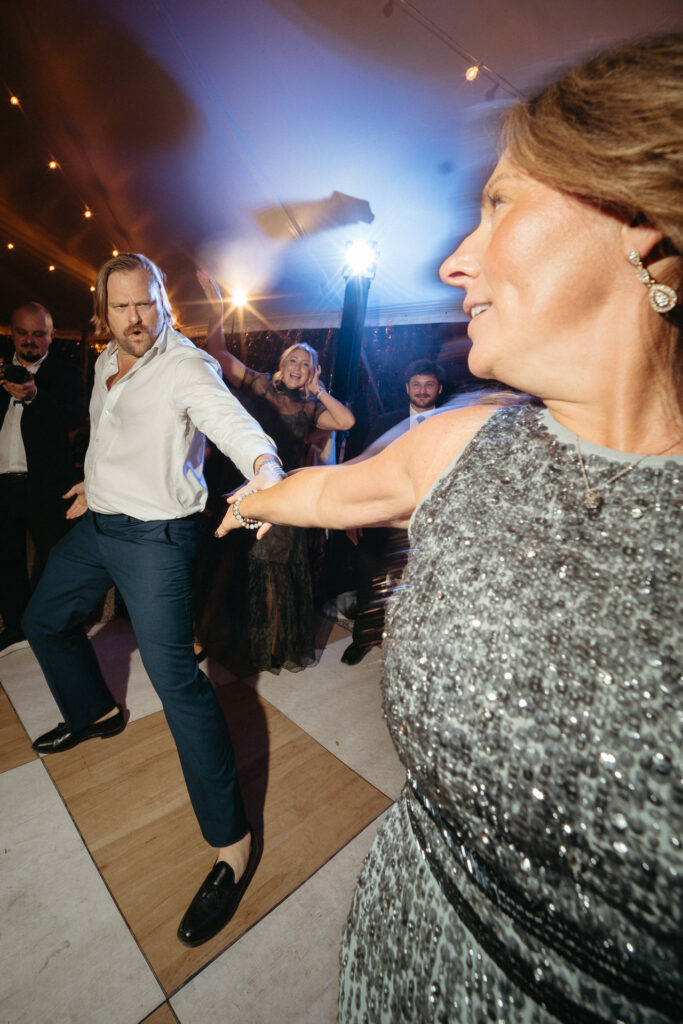 Guest in a white shirt dancing with a guest in a sequined dress