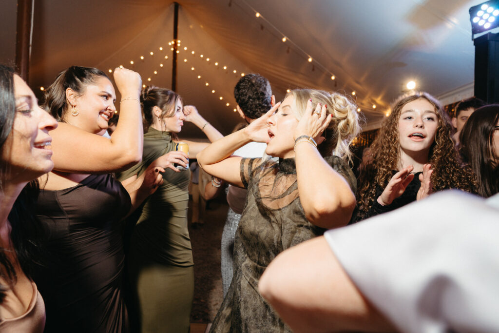 Guests dancing together under the tent