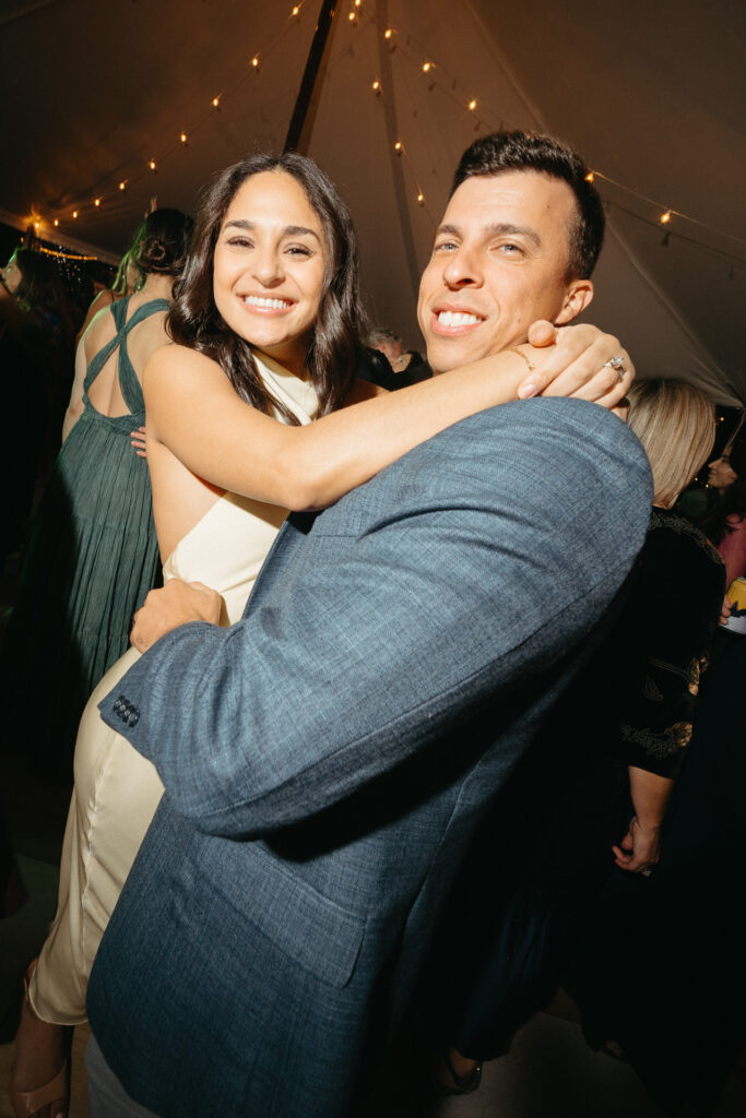 Two guests hugging and smiling on the dance floor