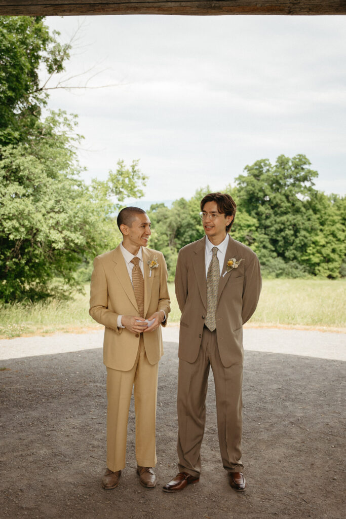 Two people in tan and taupe suits waiting at the end of the path