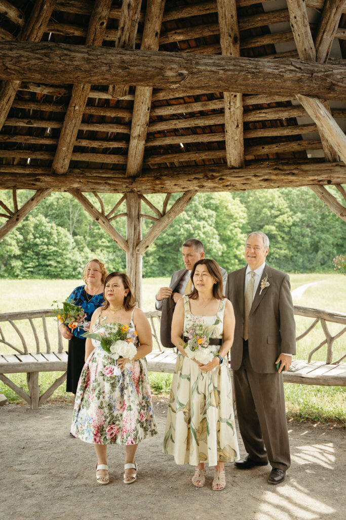Guests gathered under the wooden gazebo