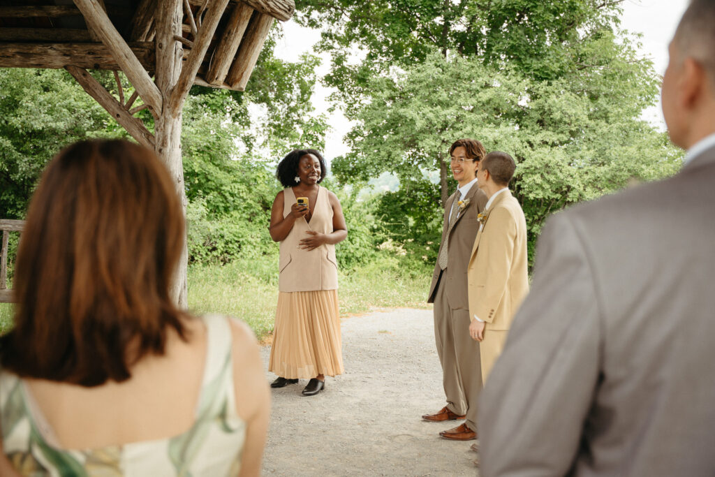 Guests speaking and laughing with the couple in the gravel clearing