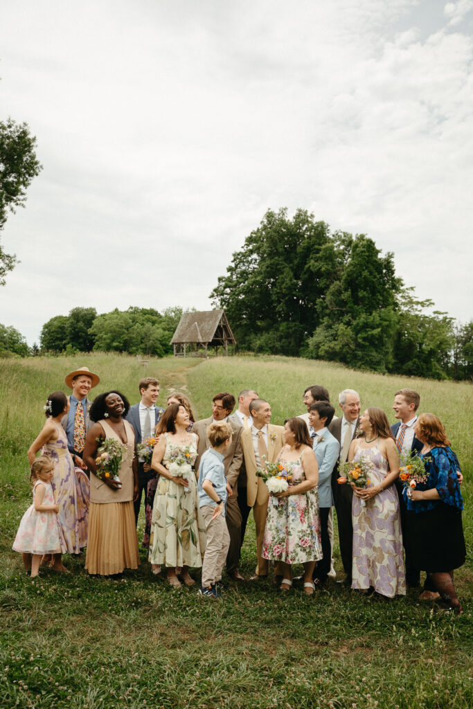 Group portrait of everyone in the field with the gazebo behind them