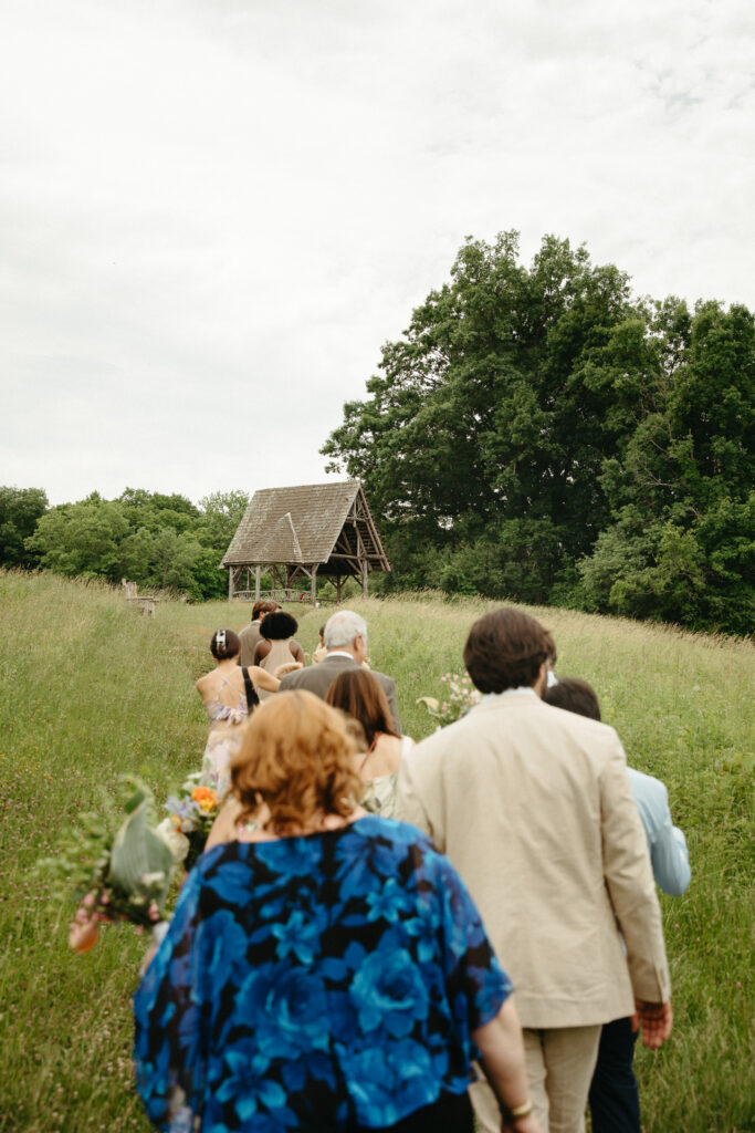 Guests walking through the field toward the gazebo
