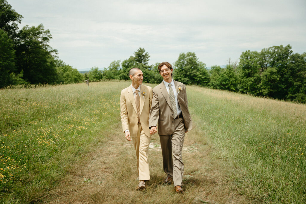Couple walking toward the camera along a mown path