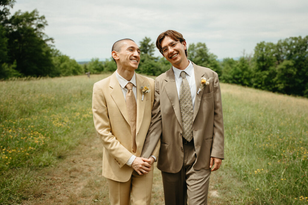 Couple standing close and smiling in the meadow