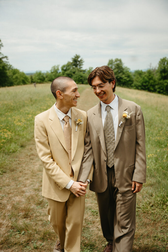 Couple leaning together and smiling in the field
