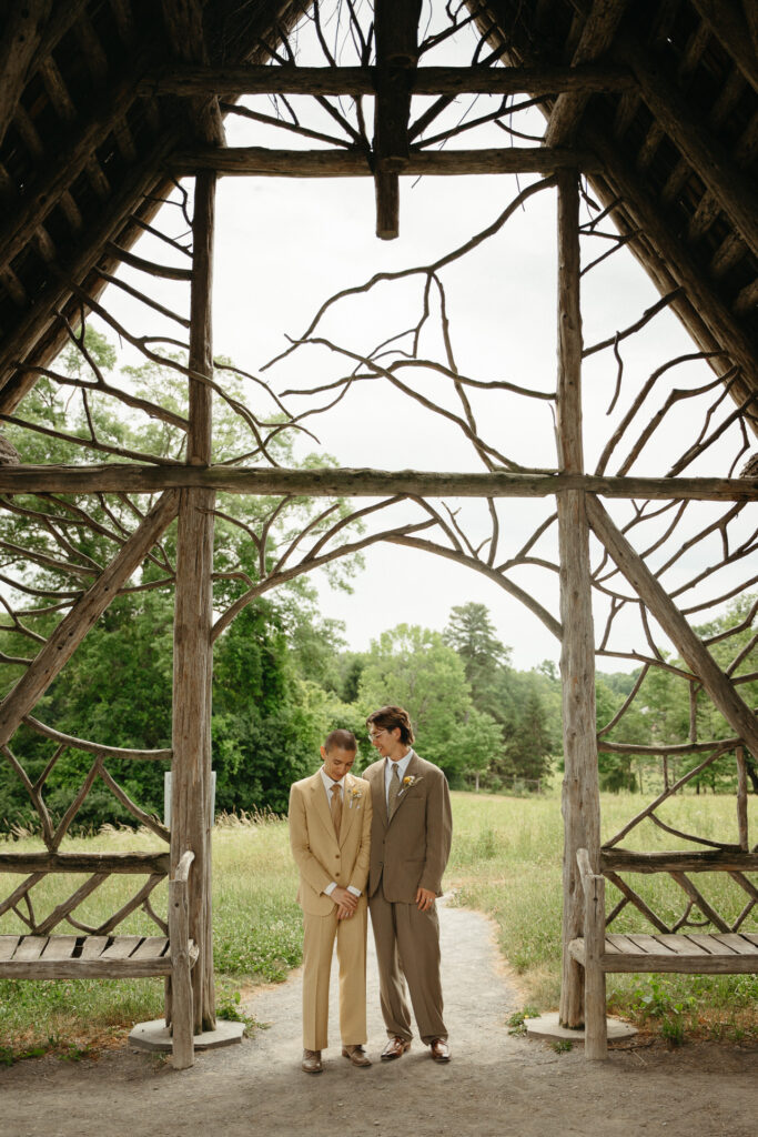 Couple standing together inside the gazebo, seen through its branches